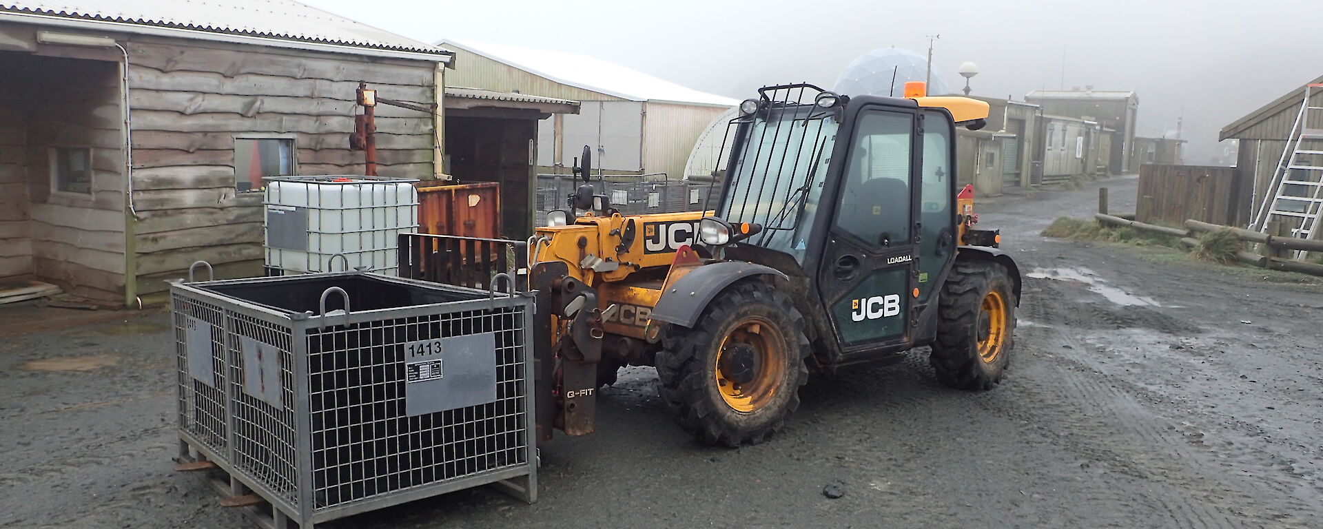 The station JCB with a cage pallet