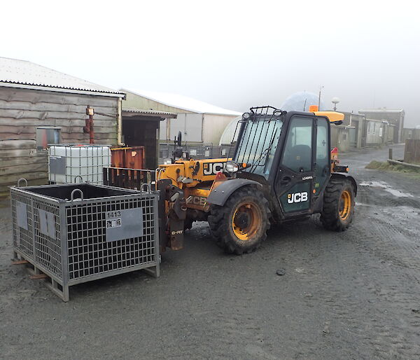 The station JCB with a cage pallet