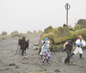 Expeditioners dressed as Superheroes being chased by Danielle dressed as a Kelp Monster