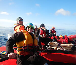 Danielle, Chris H, Tim, Rich and Chris B stop in the IRBs off the coast for a cuppa after resupplying the huts on Macquarie Island