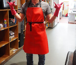 Angus with apron and rubber gloves watching the darts competition at Macca