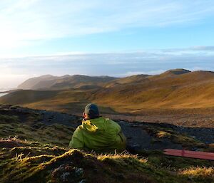 Chris sitting with a cuppa watching the sunset on the plateau