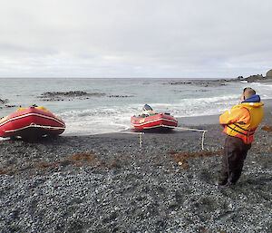 Two IRBs on the beach at Brothers Point — Chris Howard has both lines taut to keep them secure