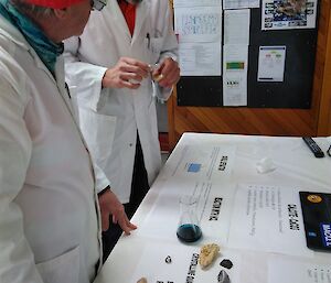 Peter Lecompte and Norbert Trupp examine one of the many hands-0n science displays iin the Macca mess for National Science week