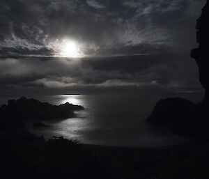 A view out to the moon, clouds and the silvery sea — taken from a track while spotlighting for petrels at night on Macquarie Island.