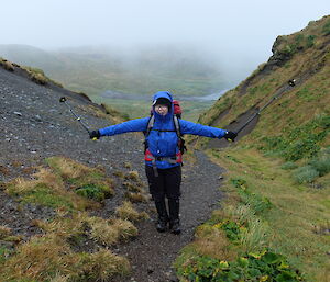 An expeditioner heading back to station along a track on Macquarie Island.