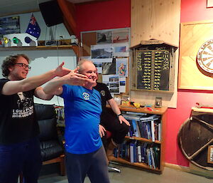 Macca darts players Angus & Peter virtual handshaking with the Davis team on winning the final game against Davis in the recent inter-station darts tournament