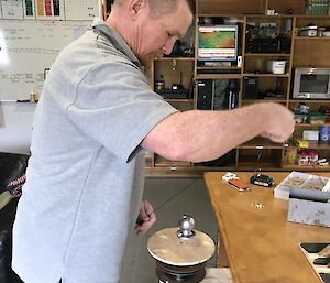 Chris Howard setting up the sushi train cranking mechanism in the Macca mess