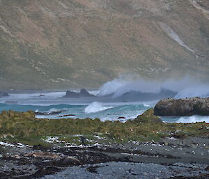 Looking south along the west coast of the isthmus with waves crashing onto the beach