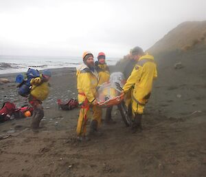 The rescue team have fitted the wheel attachment to the stretcher containing Angus to help distribute the weight as they carry it along the beach towards the waiting Polaris