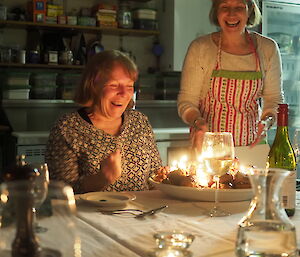 Ali with her cake — a pile of coffee cream filled coffee-chocolate coated profiteroles — with candles