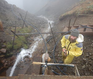 Greg Sandrey station plumber disconnecting the station water supply and draining the dam