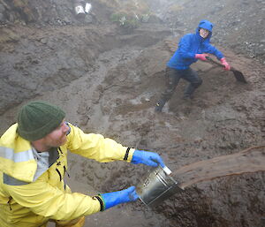 To keep the slurry moving Tim redistributes water while Cathryn digs the mud out