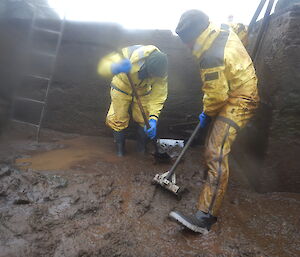 Tim & Greg encourage a lot of mud through a rather small hole in the base of the dam