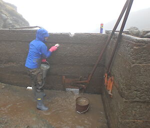 Cathryn scrubbing the dam wall