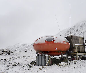 The googie or smartie hut at Waterfall Bay covered in snow