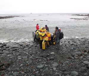 Bidding farewell to the winterers leaving the island — hugs on the beach before the zodiac takes them to the waiting ship