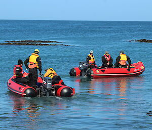 Chris climbs into the boat with Luke and Cathryn after launching it from the beach as Danielle, Stu and Tommy pass in the other boat