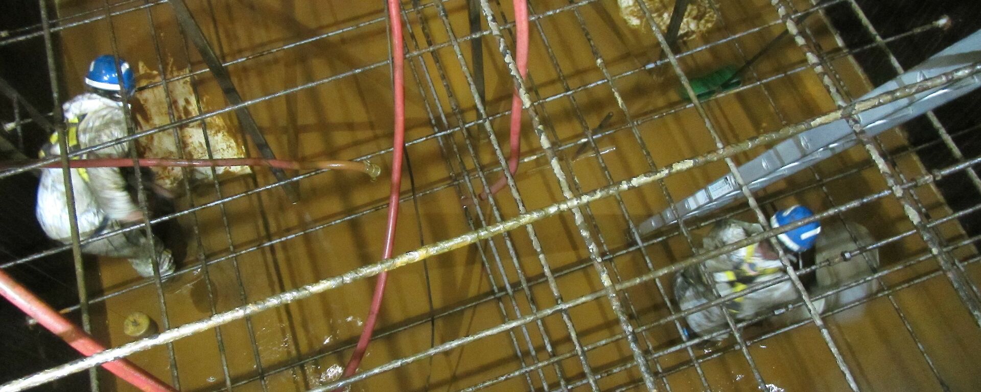 Plumbers cleaning the water tanks