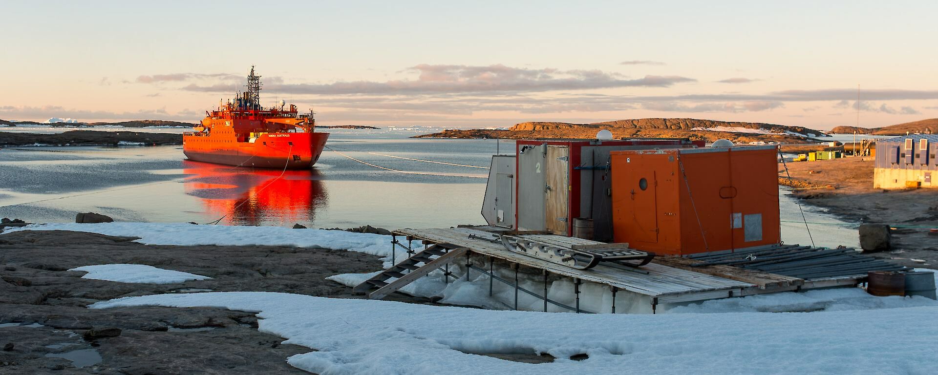 The Aurora Australis at Mawson station at sunset