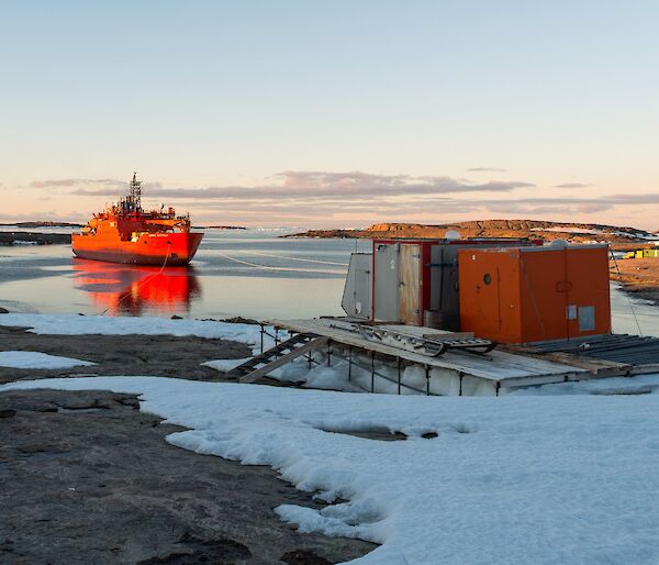 The Aurora Australis at Mawson station at sunset