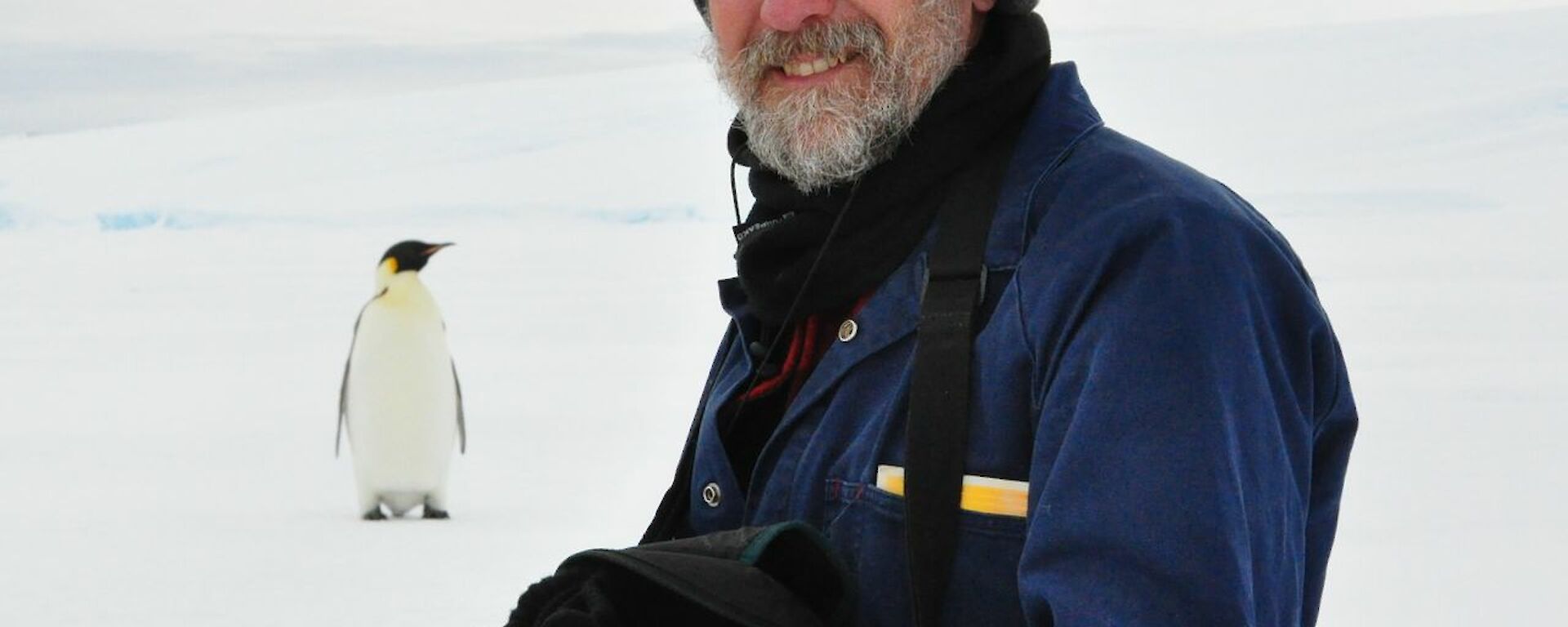 Rob Cullen pictured with an emperor penguin at casey satation in 2010