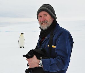 Rob Cullen pictured with an emperor penguin at casey satation in 2010