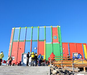 The Mawson team standing outside the carpenter’s workshop which is know as The Lorikeet due to its many colours