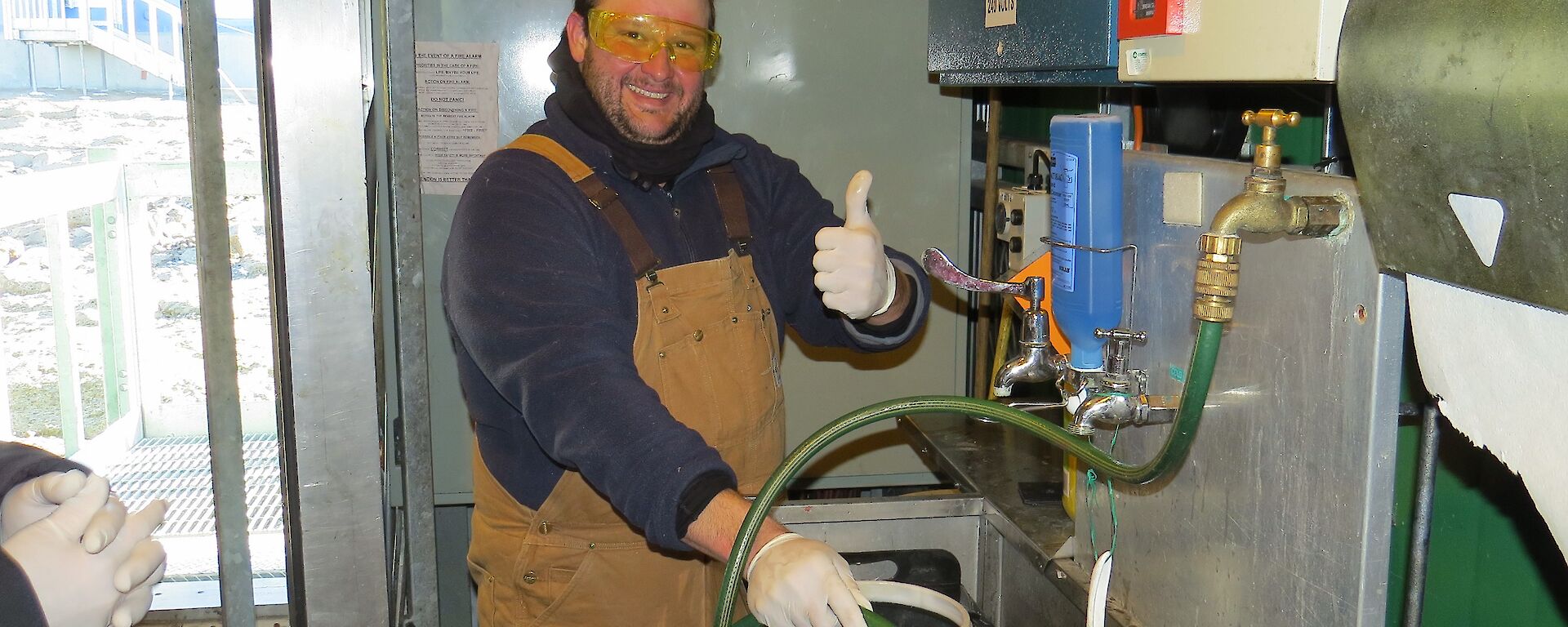 Robert Baker (Robbie) washing grey water contaniers