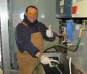 Robert Baker (Robbie) washing grey water contaniers