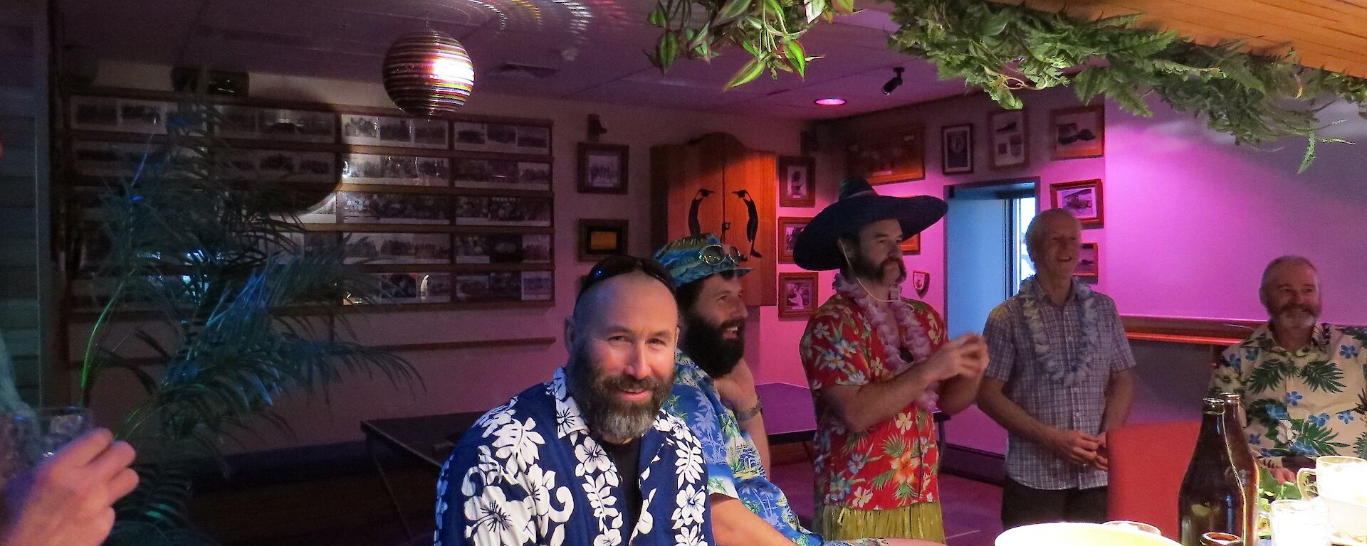 Expeditioners dressed in hawaiian shirts gather for a theme party