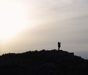 Taken from a distance, this incredible silhouette shows Trev looking out from the top of the hill across the plateau
