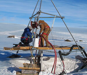 The new melt bell being winched into place