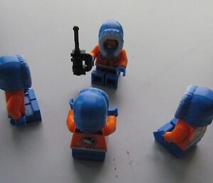 Lego men being briefed by radio