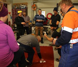 Station members playing Two-up in the chippies workshop