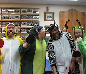 Expeditioners in animal costumes (tiger, dinosaur, zebra and frog) holding ping pong paddles