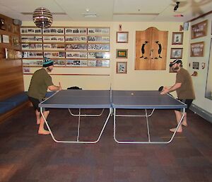 Expeditioners playing a round of singles ping pong