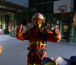 Charlie, the team leader giving the thumbs up for well done team while wearing full fire fighting uniform including breathing apparatus