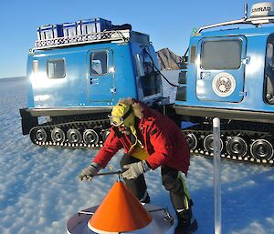 Cones marking the Ski landing area are removed with a blue Hägglunds in the background