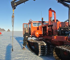 Mawson station leader leaning up against the Pioneer working hard