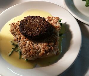 Main course of Barramundi coated in oatmeal topped with black pudding