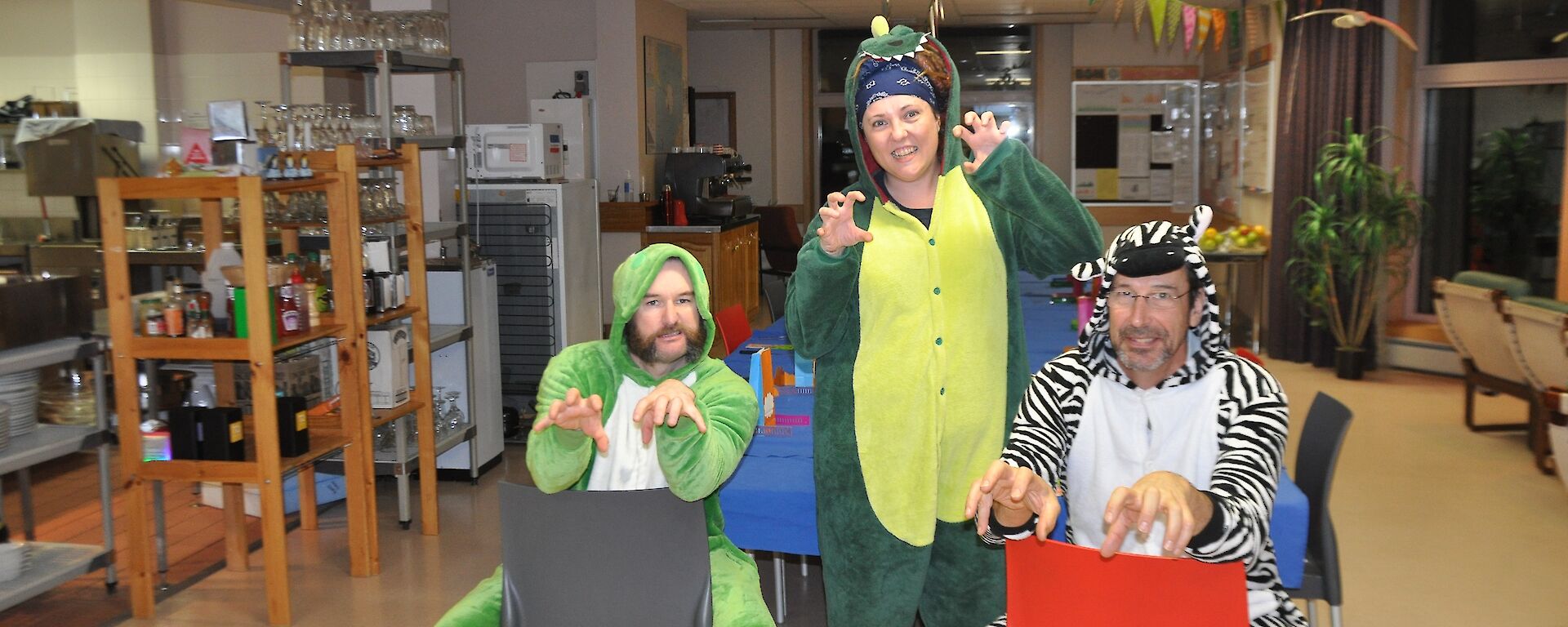 Three expeditioners dressed in animal costumes for the party