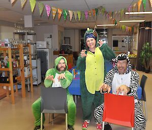 Three expeditioners dressed in animal costumes for the party