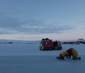 Drilling the sea ice to find what its depth is