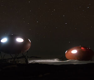 The light comes out of the huts at night making them look loke flying sauces