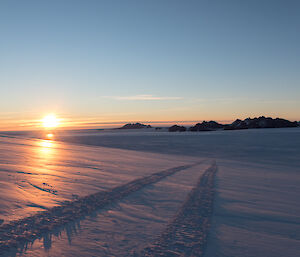 Looking over the ice of the plateau towards the masson Ranges the sun sets