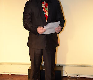 Male expeditioner in suit reciting a poem.