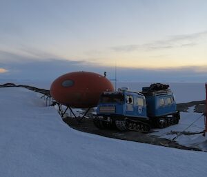 The blue Hägglunds at Bechervaise Island next to one of the huts, not your everyday plumbers van.