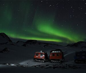 It is 0800 hours in the morning and still like night. An aurora is visible over the top of the Hägglunds.