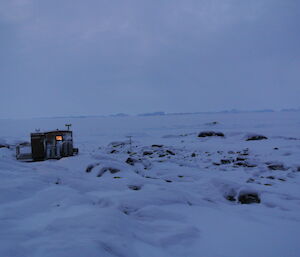 The small hut on Macey Island in the snow.